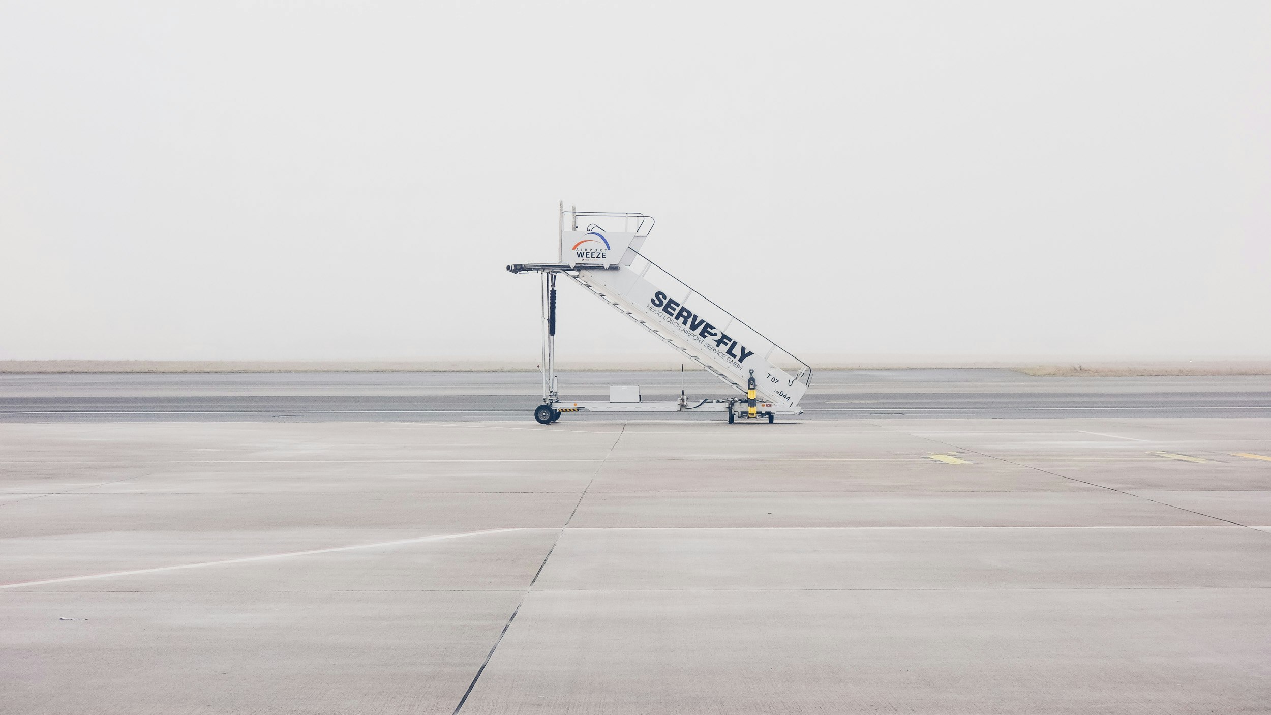 white airliner stairs on runway